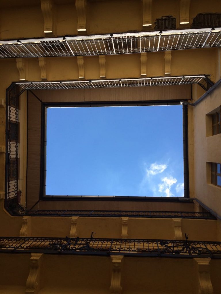 The view looking up from the courtyard at our apartment building