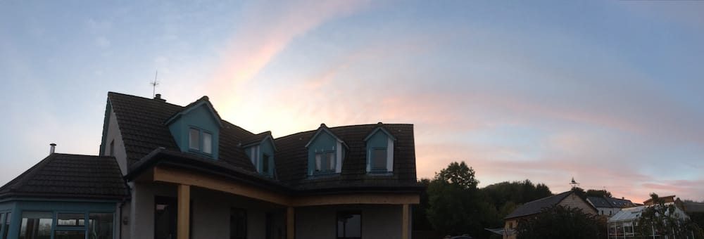 Panorama view of a sunrise at our housesit house, looking back south
