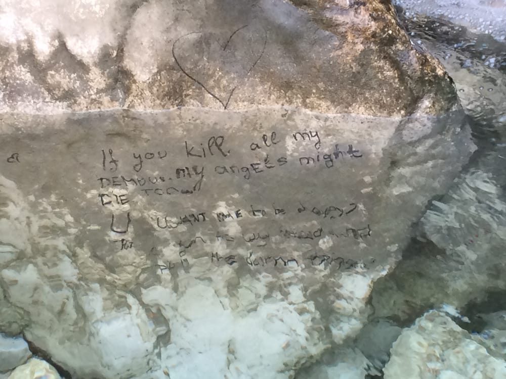 On the northern side of the Kotor fortress there's a river/waterfall with a message, closeup