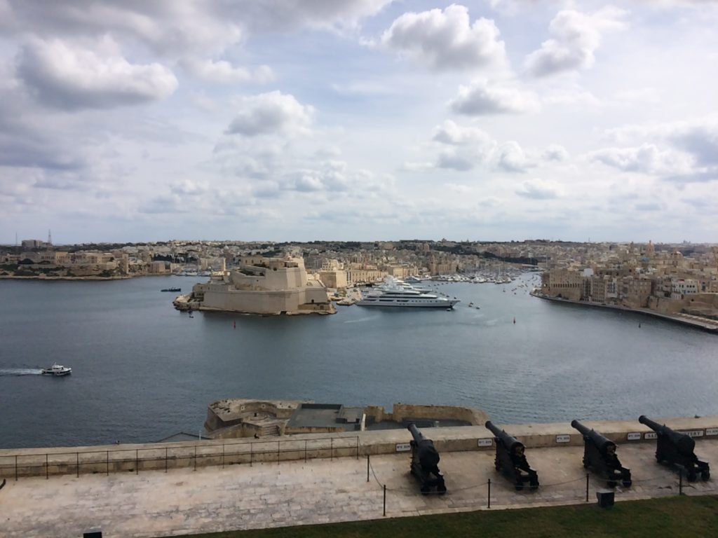 Looking across St. Elmo Bay at a super yacht in the harbour